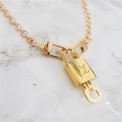 louis vuitton lock necklace real vs fake|knock off Louis Vuitton earrings.